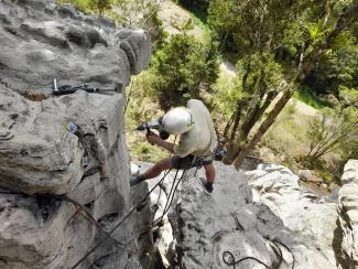 Bolting hangers on Valley Road Crag