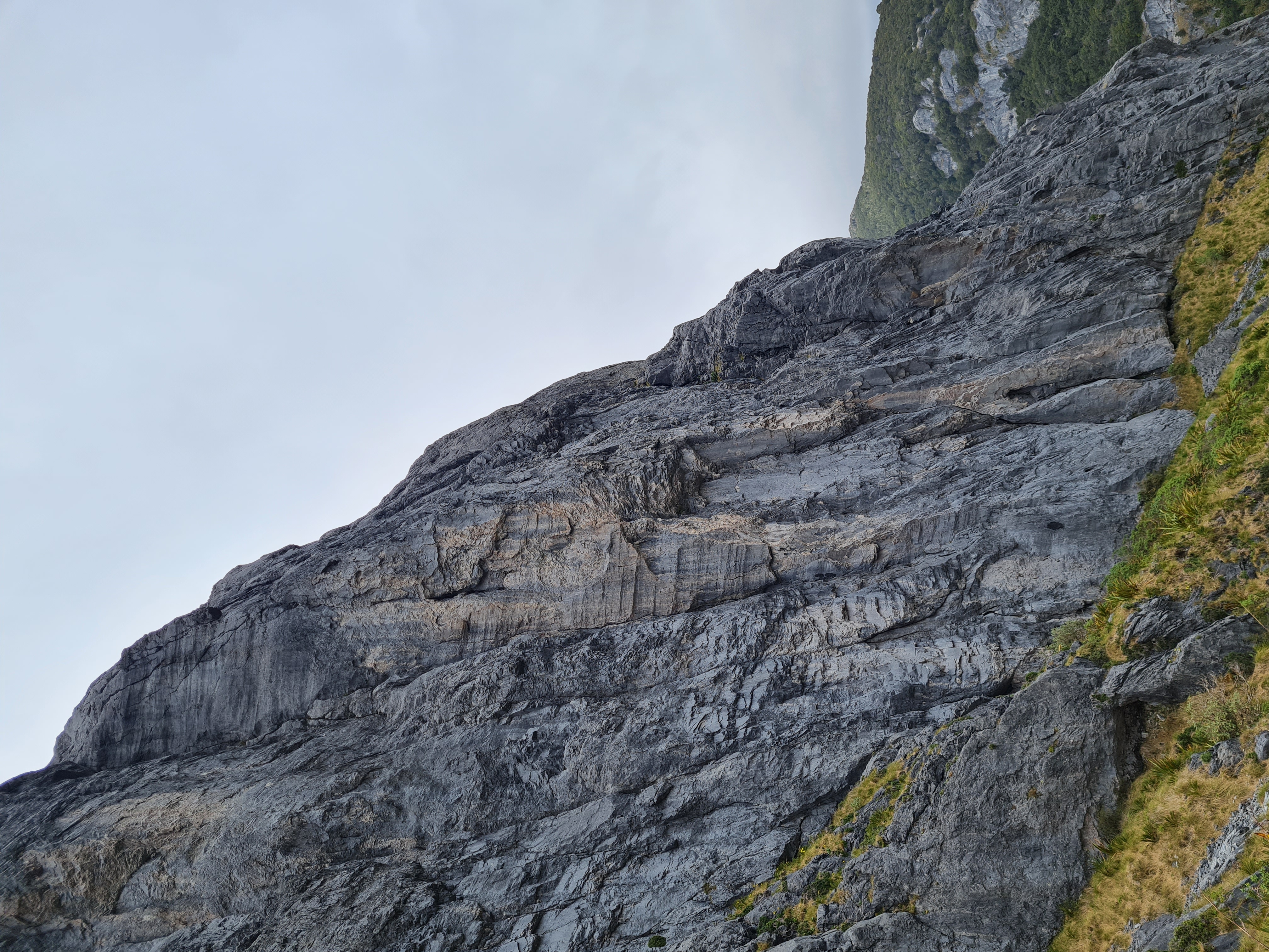 There will be Blood follows the giant corner system facing the camera; belaying at the ledge over halfway up where the angle changes.