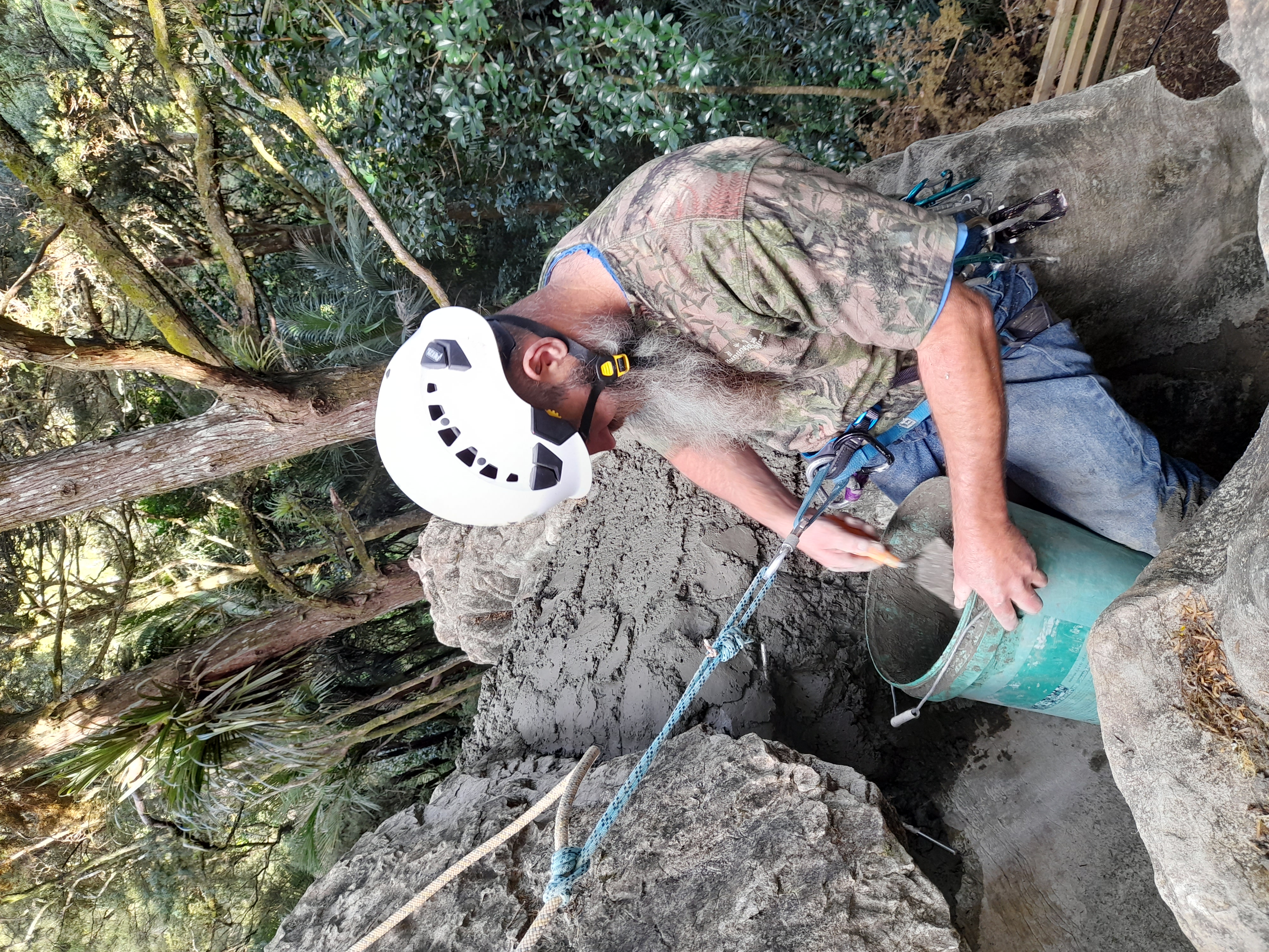 Putting Concrete around a rock to ensure it does not move.