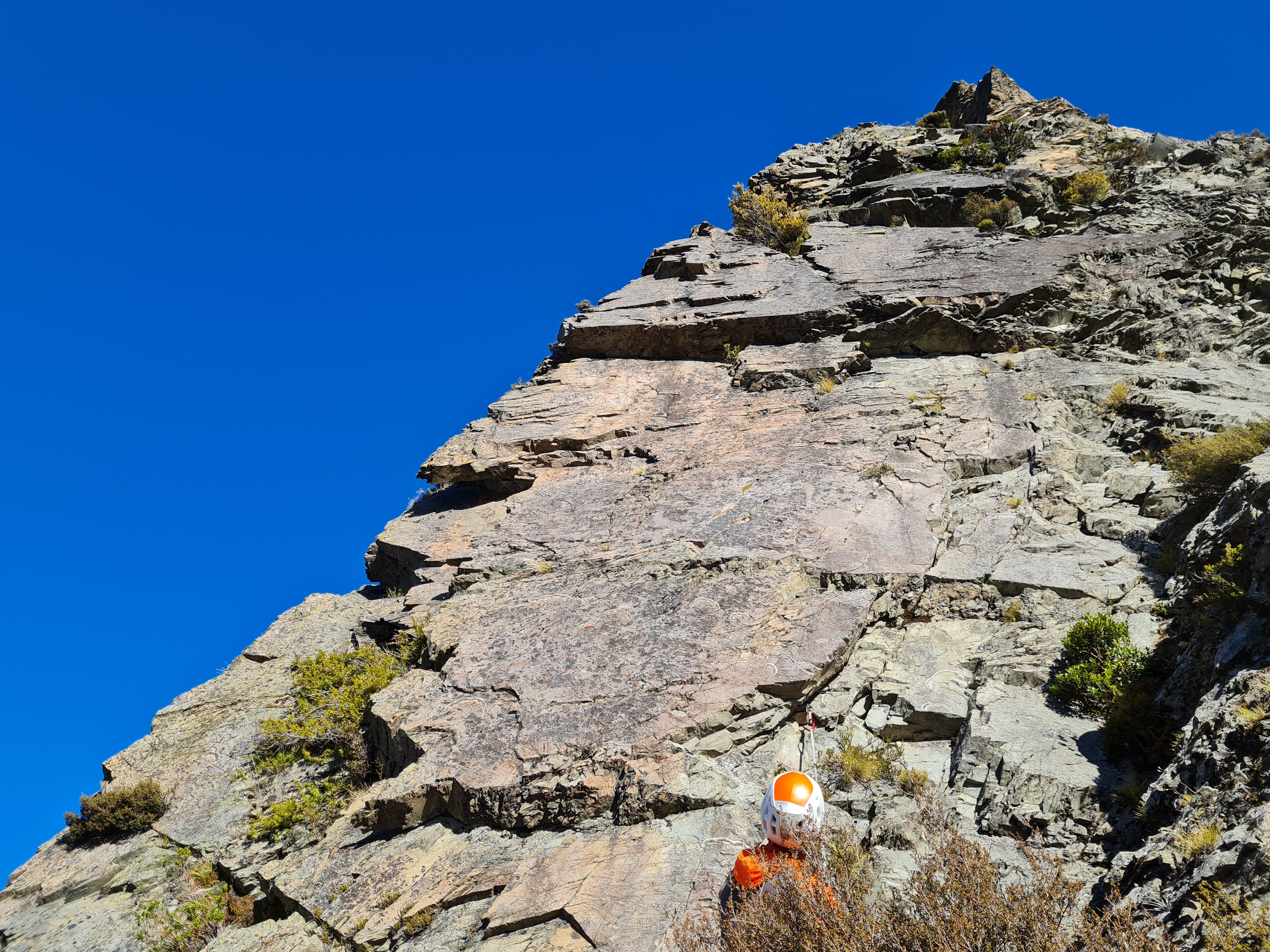 P8. FA climbed up around to left of arete, but suspect better rock and climbing on face (crack to bush or face climbing to right).