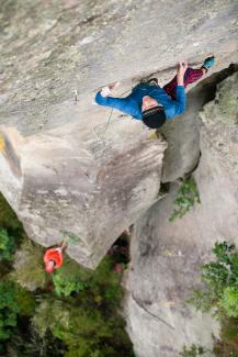 Climber climbs route on ignimbrite pinnacle